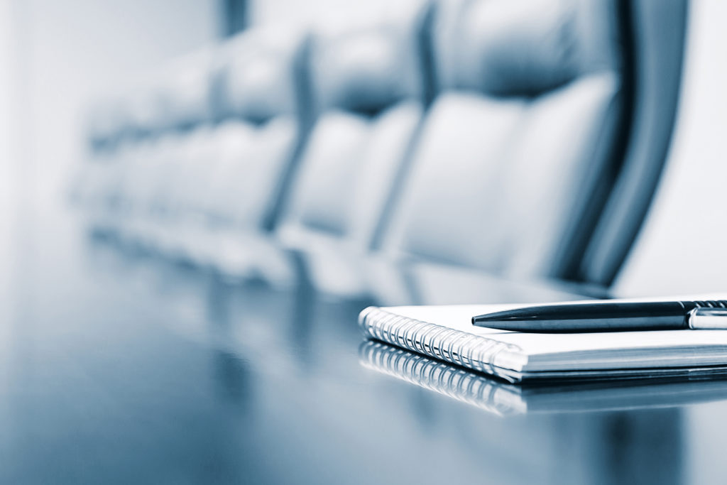 Notepad kept on table in empty conference room