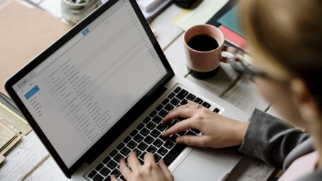 Businesswoman Checking E-mail Online on Laptop